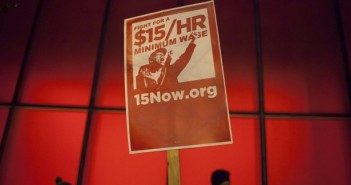 A protest sign is pictured during a rally to raise the hourly minimum wage to $15 for fast-food workers at City Hall in Seattle