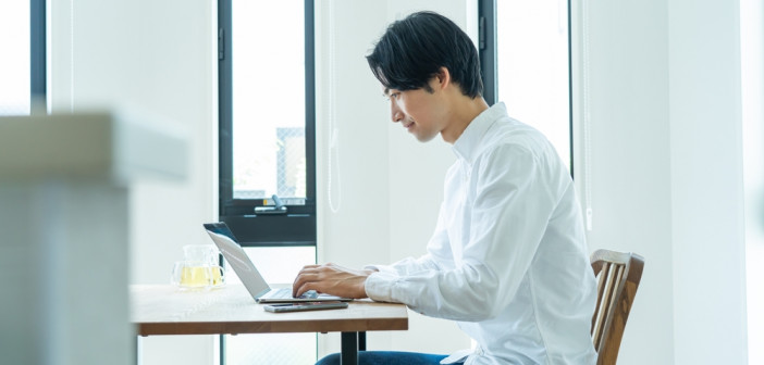 Japanese,Man,Working,On,A,Computer,At,Home