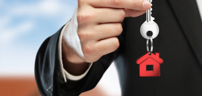 Hand,Handing,Key,On,Cottage,Background