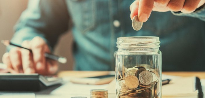 Businessman,Holding,Coins,Putting,In,Glass.,Concept,Saving,Money,For