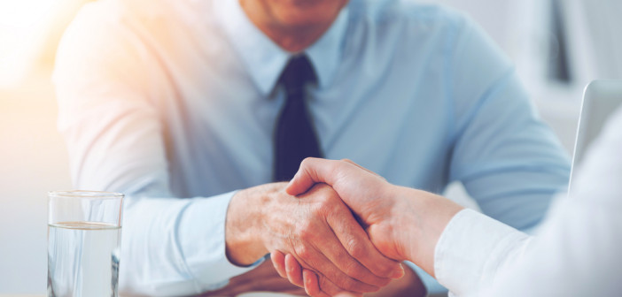 Good,Deal.,Close-up,Of,Two,Business,People,Shaking,Hands,While