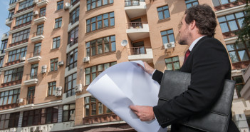 5 Essential Tips for a Successful Real Estate Development Architect,Looking,At,Plan,And,Apartment,Building.,Architect,Reviews,Plans