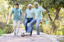 Two,Senior,Man,With,Son,Having,Fun,While,Playing,Football