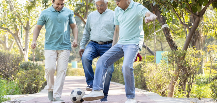 Two,Senior,Man,With,Son,Having,Fun,While,Playing,Football