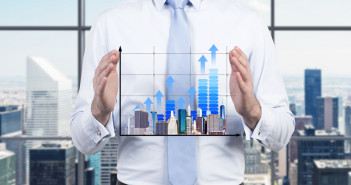 Businessman,Is,Holding,A,Bar,Chart.,A,Concept,Of,Development.