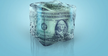 Frozen,American,Usd,Money,In,Ice,Cube,On,A,Blue