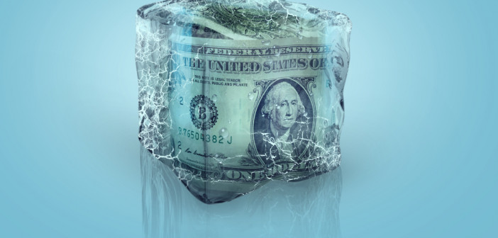 Frozen,American,Usd,Money,In,Ice,Cube,On,A,Blue