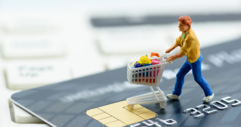 Retail sales rose solidly last month in a sign that consumers are still spending freely Miniature,Figurine,:,A,Shopper,Pushes,A,Shopping,Cart,On