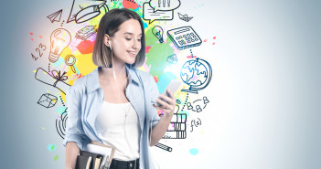 Beautiful,Young,College,Student,With,Smartphone,And,Stack,Of,Books