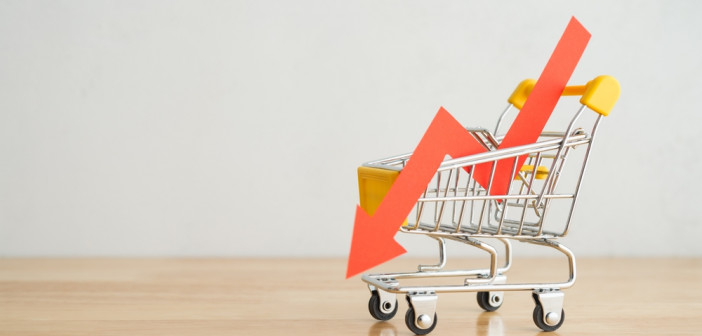 Shopping,Trolley,With,Red,Chart,Falling,Down,On,Wooden,Table