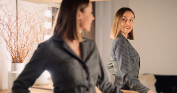 Self-confident,Woman,Looking,At,Her,Reflection,Into,The,Mirror,Indoors.