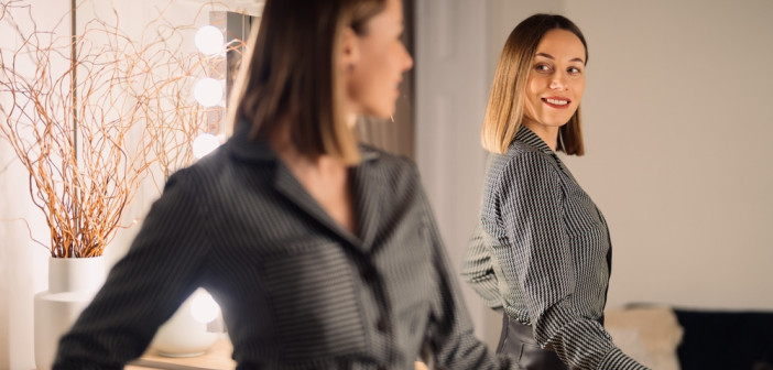 Self-confident,Woman,Looking,At,Her,Reflection,Into,The,Mirror,Indoors.