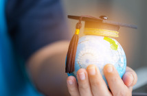 Education,In,Global,World,,Graduation,Cap,On,Businessman,Holding,Earth