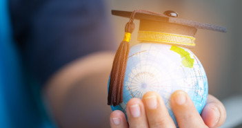 Education,In,Global,World,,Graduation,Cap,On,Businessman,Holding,Earth