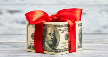 Dollars,Wrapped,By,Red,Bow.,Money,Is,Best,Present.