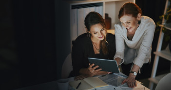 Striking,Success,As,A,Team.,Two,Businesswomen,Using,A,Digital