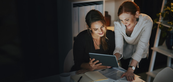 Striking,Success,As,A,Team.,Two,Businesswomen,Using,A,Digital