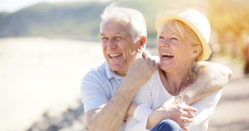 Senior,Couple,Relaxing,By,The,Sea,On,Sunny,Day