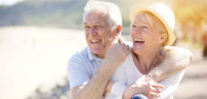 Senior,Couple,Relaxing,By,The,Sea,On,Sunny,Day