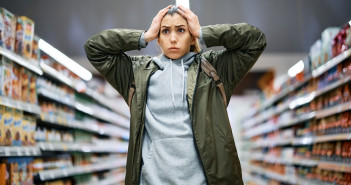 Young,Woman,Feeling,Shocked,About,Rising,Food,Prices,While,Standing