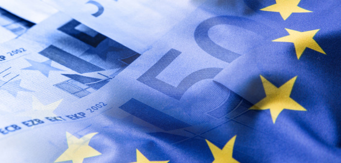 Colorful,Waving,European,Union,Flag,On,A,Euro,Money,Background.