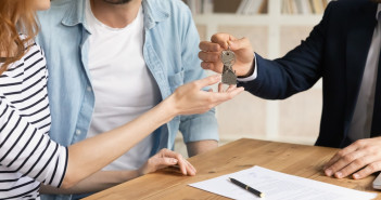 Cropped,Close,Up,View,Happy,Couple,Receiving,Keys,From,New