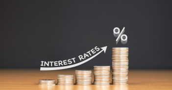 US inflation increases moderately in February; consumer spending surges Stacked,Us,Quarter,Coins,On,Wooden,Table,With,White,Illustration