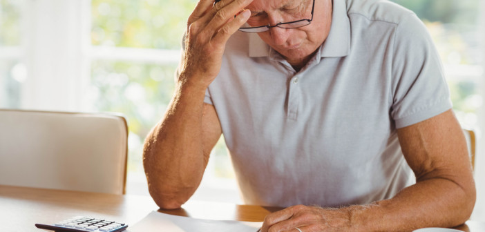 Worried,Senior,Man,With,Tax,Documents,At,Home