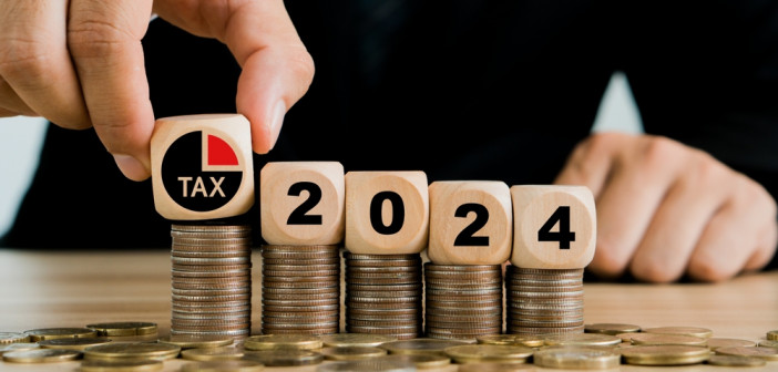 Tax,2024.hand,Putting,Tax,Icon,In,The,Wooden,Cube,For