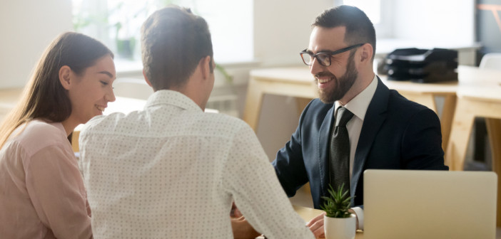 Friendly,Lawyer,Or,Financial,Advisor,In,Suit,Consulting,Young,Couple,