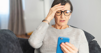 Worried,Senior,Woman,Staring,At,A,Smartphone,Screen,At,Home,