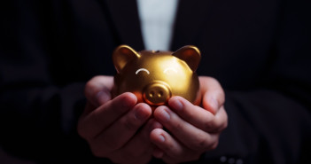Here’s the average retirement account balance — how do you compare? Business,Hand,Protecting,And,Saving,Gold,Piggy,Bank,,Stock,Funding
