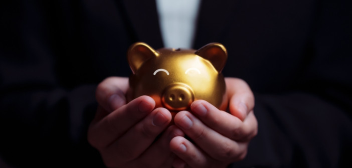 Business,Hand,Protecting,And,Saving,Gold,Piggy,Bank,,Stock,Funding