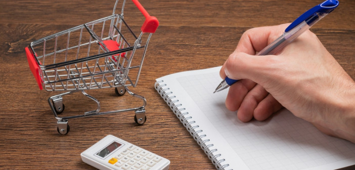 Man,Calculates,The,Budget.,Shopping,Cart,A,On,Table,With