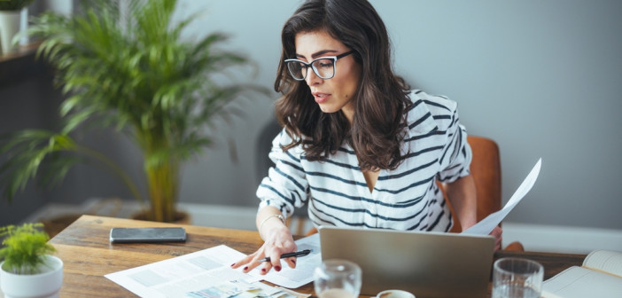 A,Smart,Business,Woman,Who,Keeps,A,Paper,Account,Using